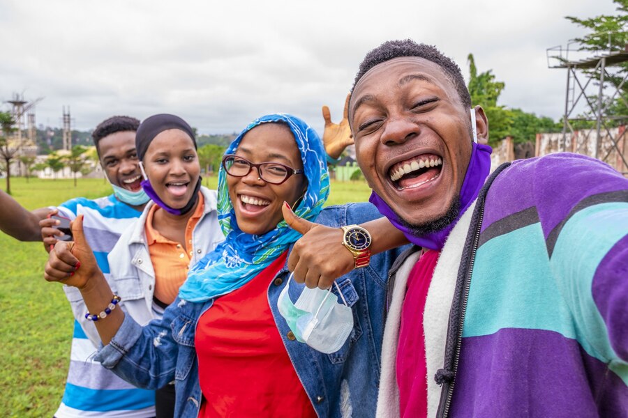 group-cheerful-african-friends-with-facemasks-taking-selfie-park_181624-43702 group-cheerful-african-friends-with-facemasks-taking-selfie-park_181624-43702